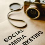 Close-up of a vintage camera on brown paper labeled with 'Social Media Marketing'.